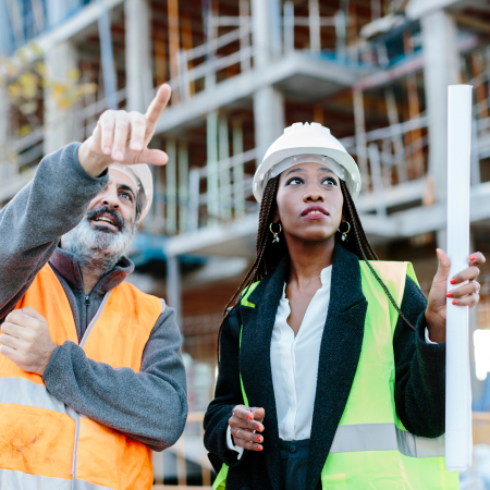 Construction worker talking with woman engineer