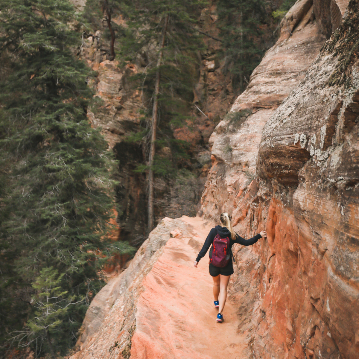 Red backpack hiking rock trails