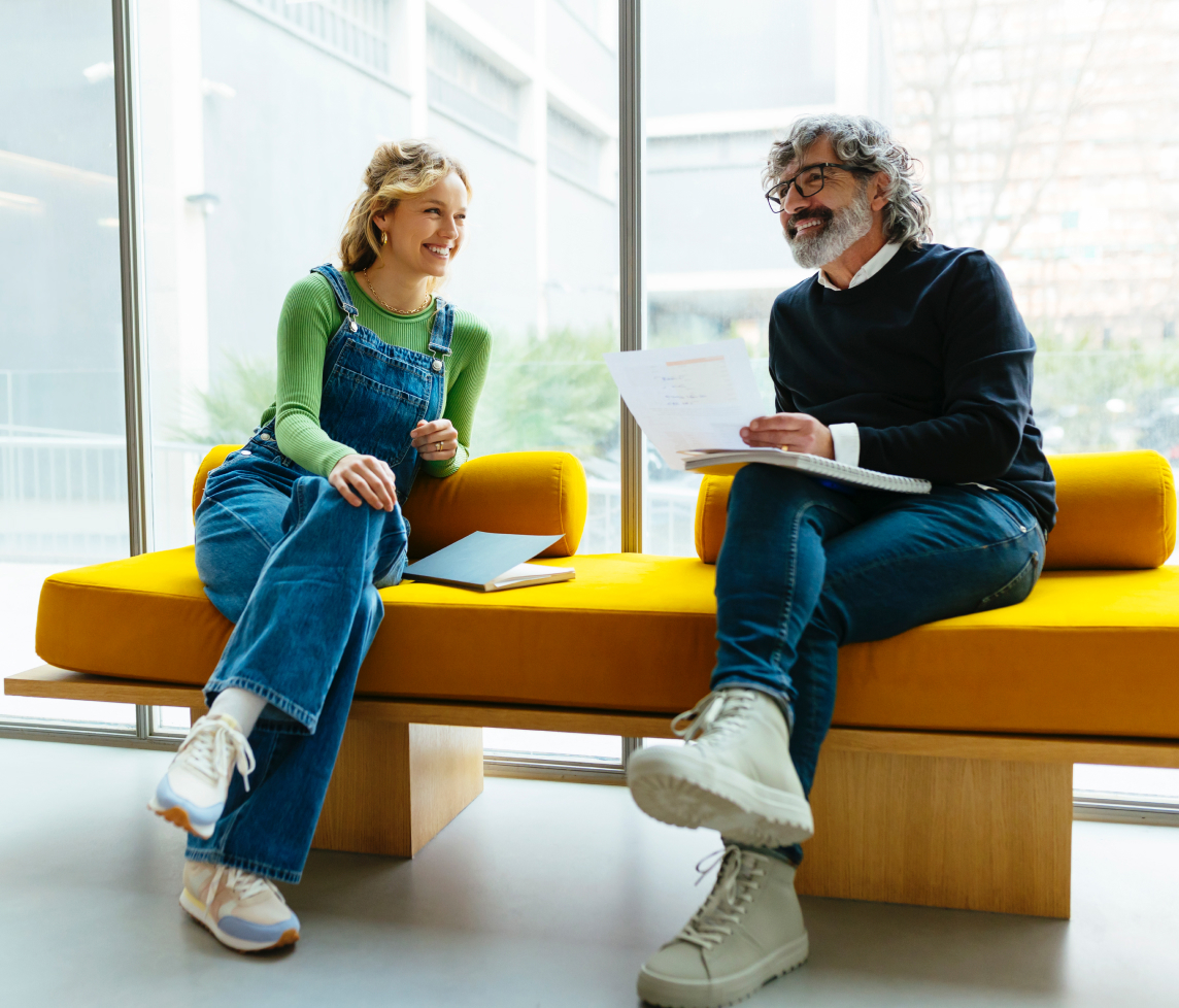 Employees laughing on couch