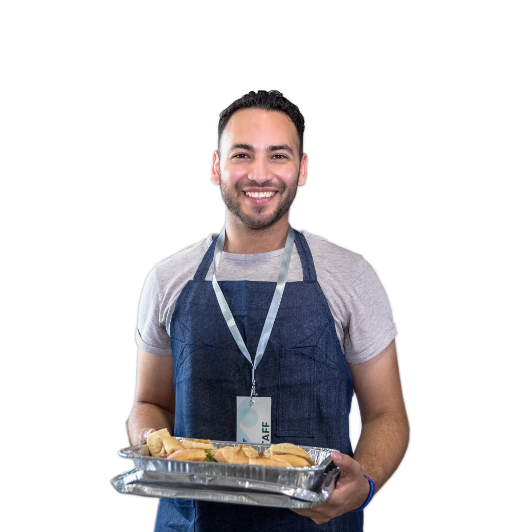 Soup kitchen staff smiling with plate of food