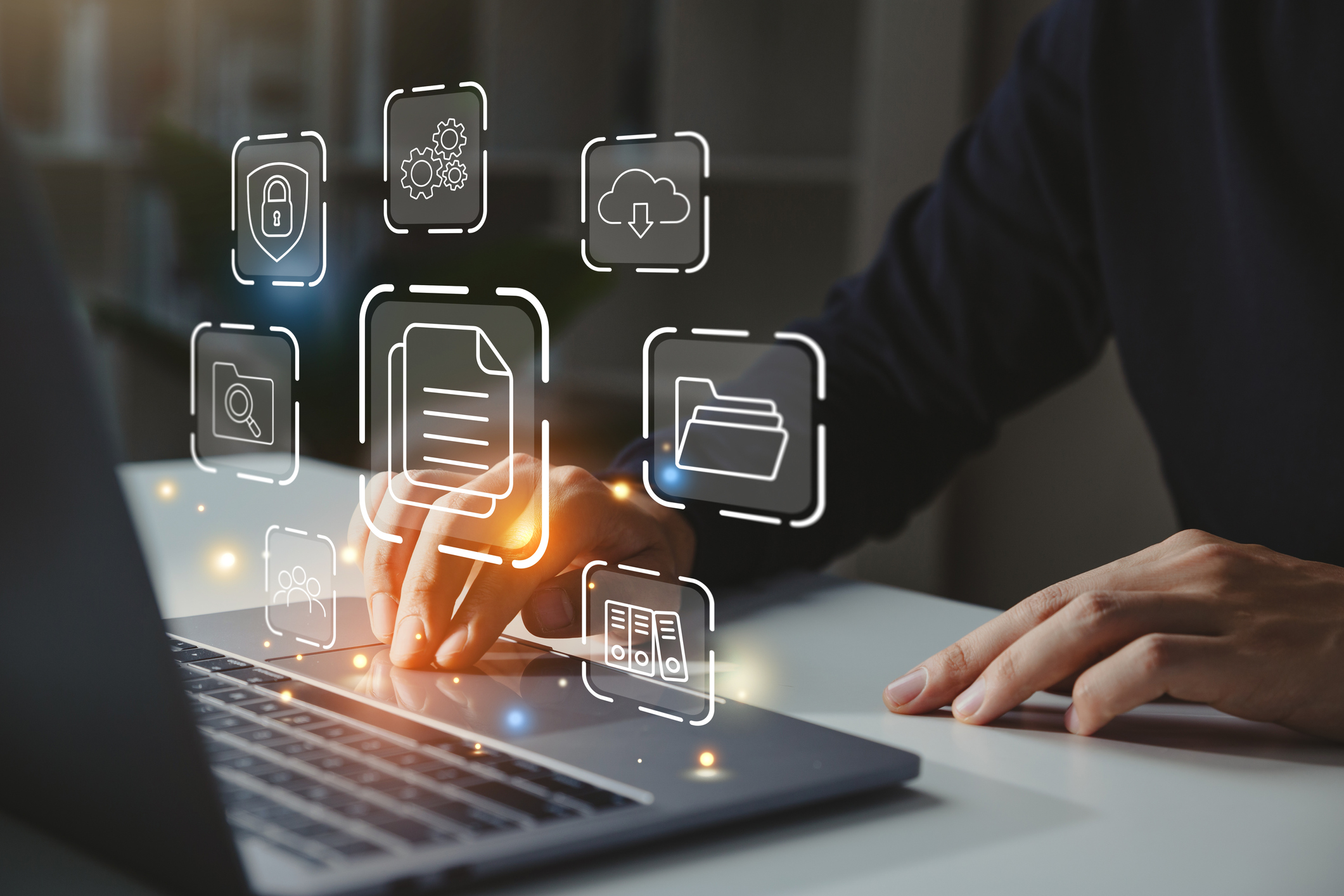 Businessman working on laptop with document management icon.