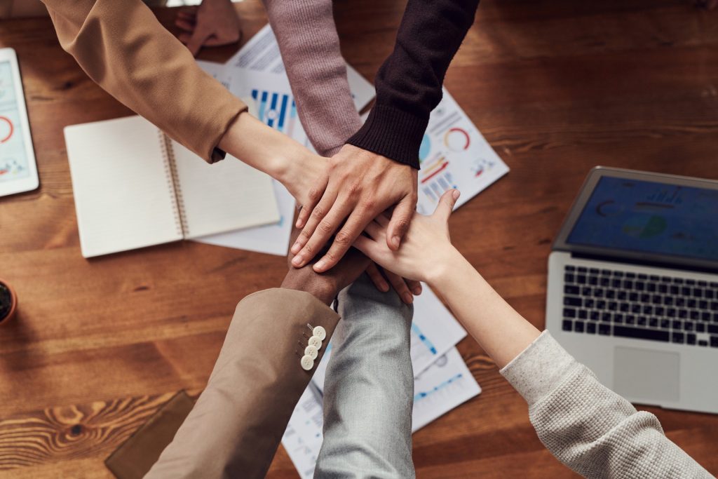 Image of people joining hands 