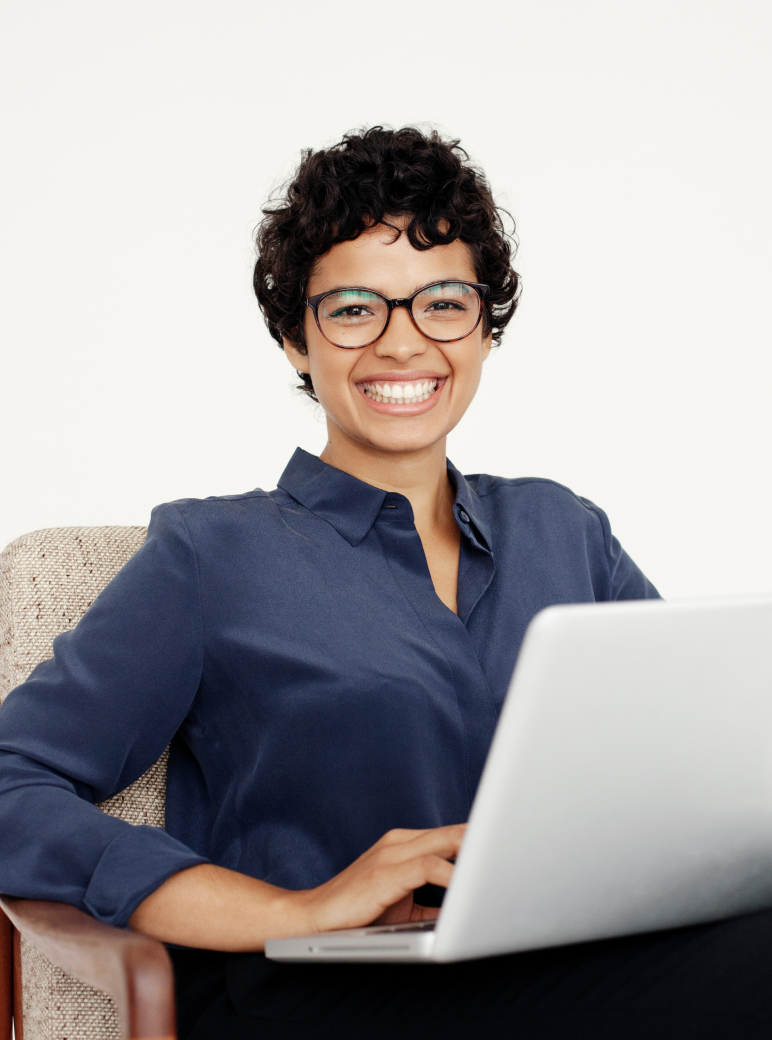 Smiling young woman using laptop tall