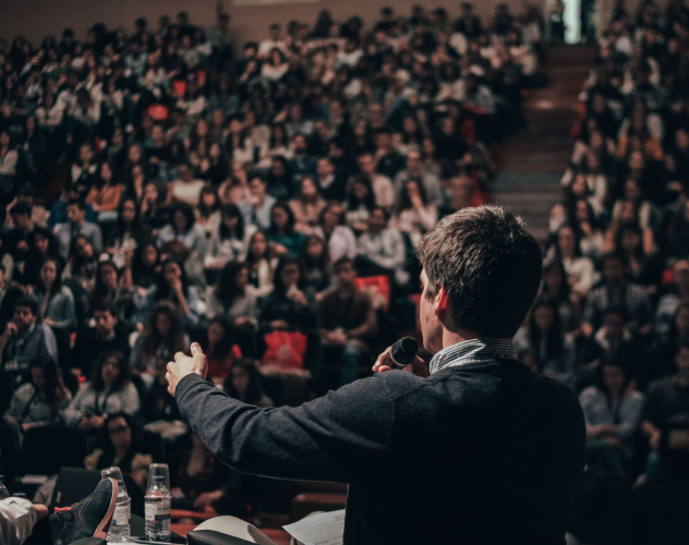 Man speaking in front of crowd