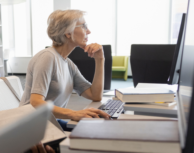 Focused senior woman researching rectangle