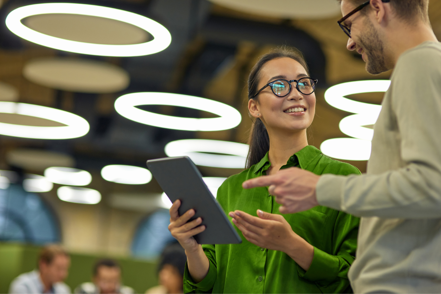 Coworkers talking holding tablet