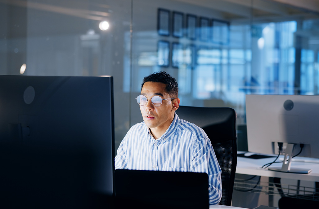 Man behind monitors working