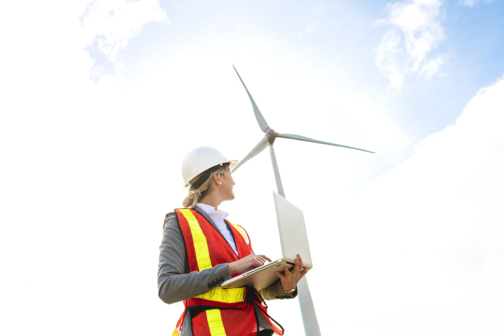 electrical worker in front of wind turbine