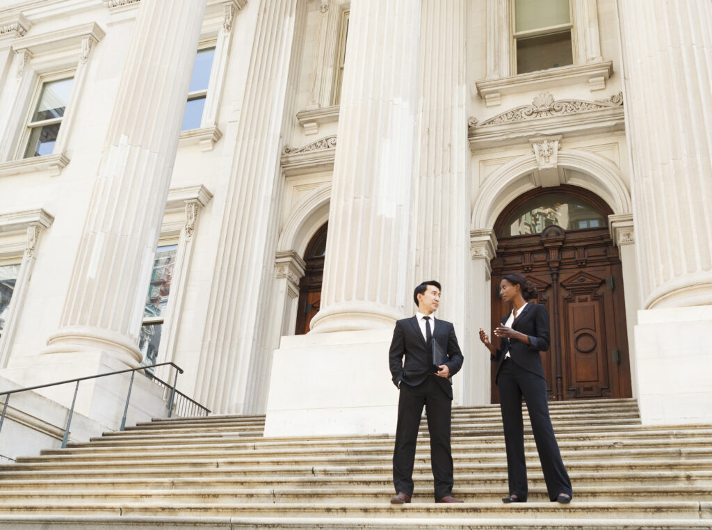 Two people having a discussion outside court